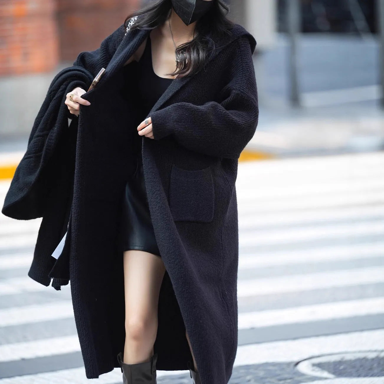 Long grey hooded knitted cardigan coat with loose fit and long sleeves.