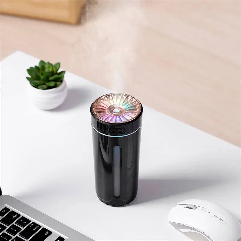 Black wireless portable humidifier with colourful lights beside car cup holder