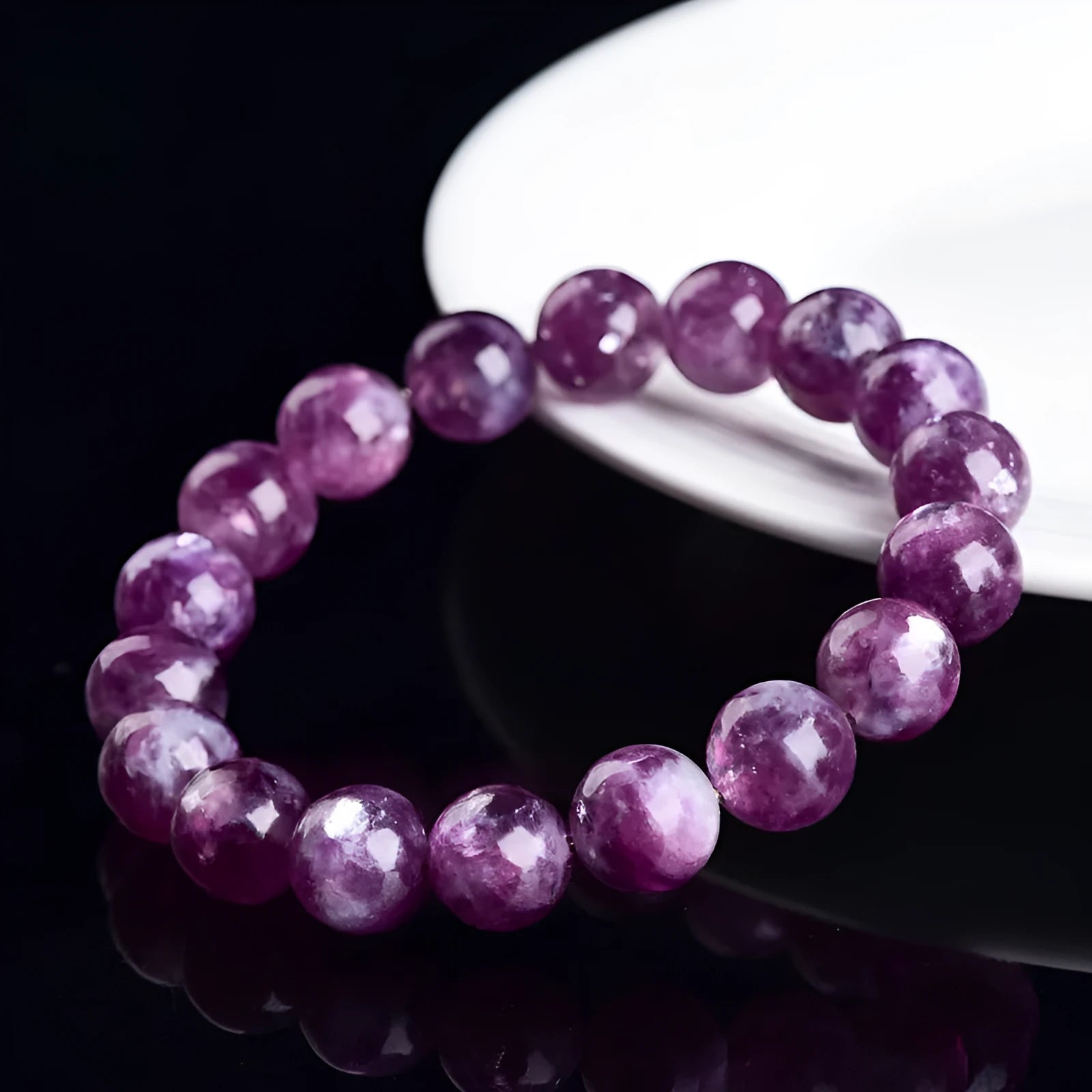 Grandmother Crystal bracelet with polished geometric beads in 5A purple on a white background.