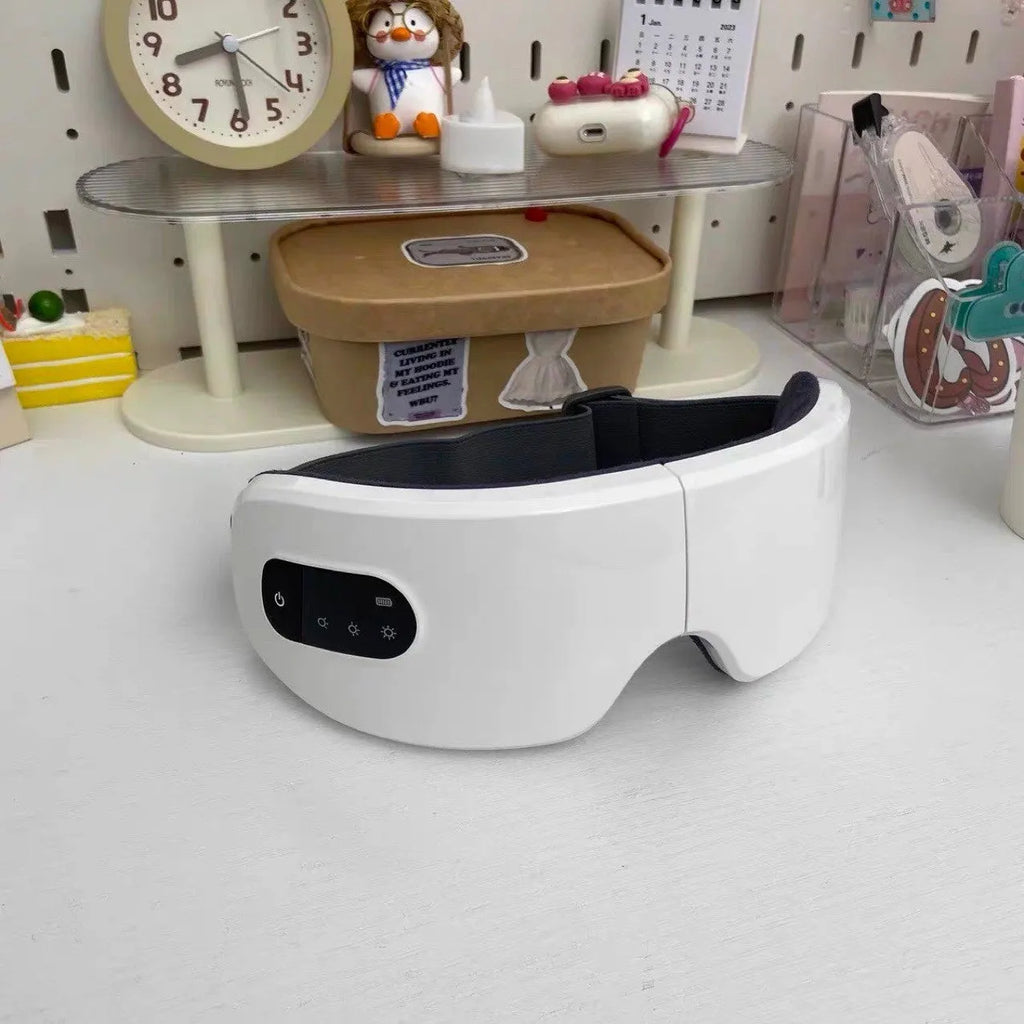 Rechargeable heated eye massager mask in white or black with foldable design for universal eye area use