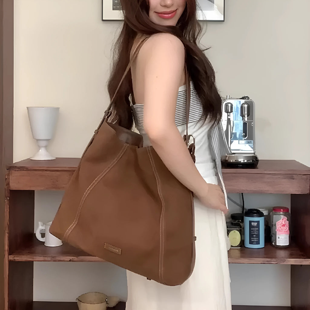 Large capacity coffee colour suede messenger bag with visible sewing line detail and single shoulder strap, shown on a plain background.