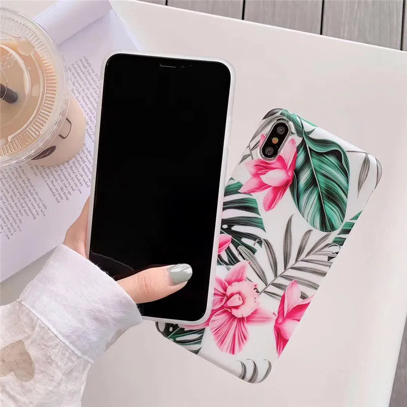 Pink floral pattern TPU back cover case for iPhone models on a table.