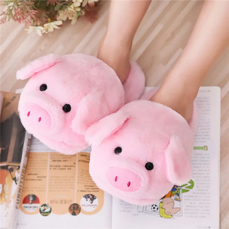 Pink pig-shaped plush floor slippers with PP cotton filling on a plain background