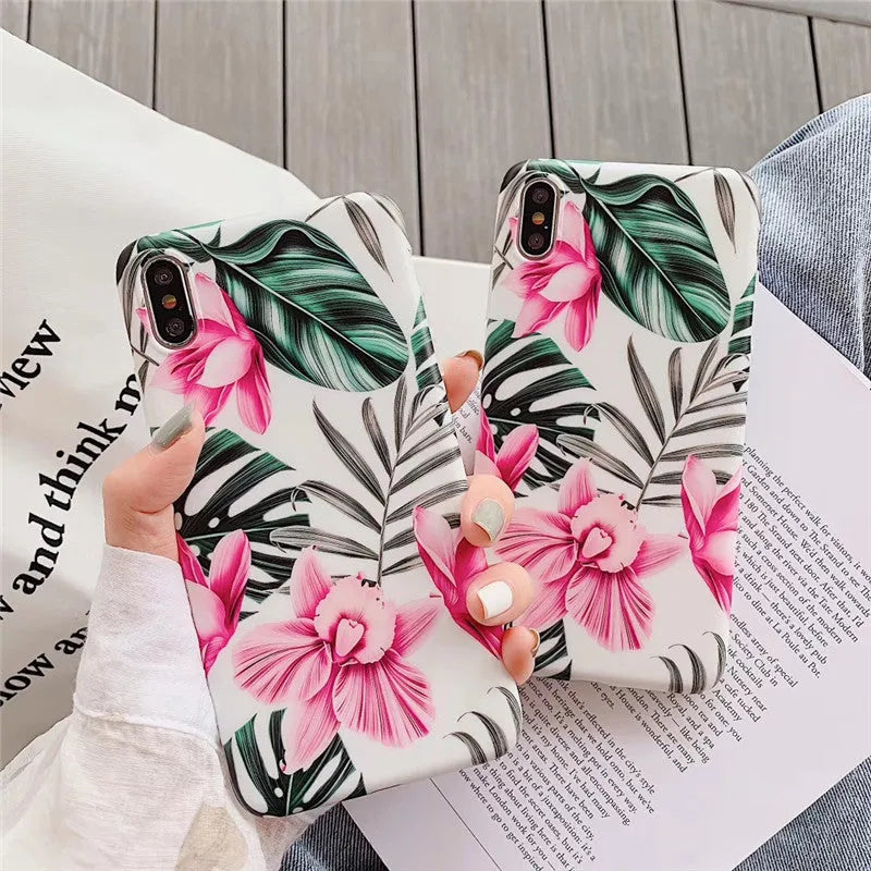 Pink floral pattern TPU back cover case for iPhone models on a table.