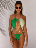 Solid green women's one-piece swimsuit on a hanger, showing hollow design.