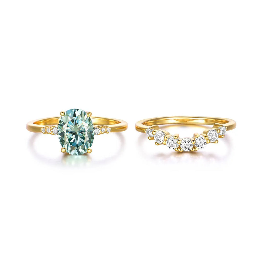 Gold S925 silver ring set with green moissanite stone, crown and geometric design, stacked on finger.