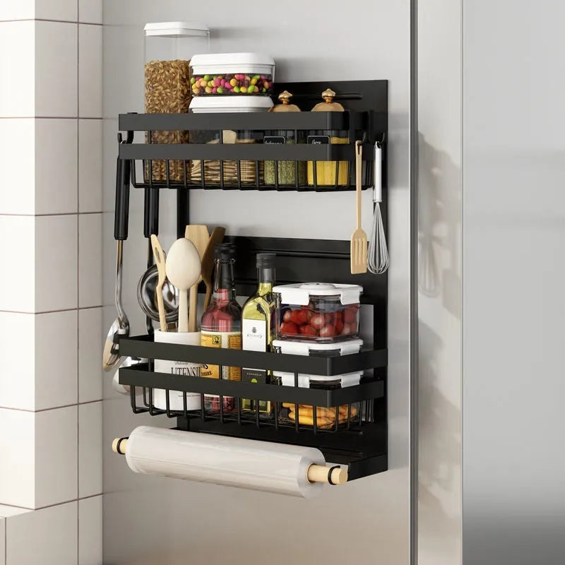 Black magnetic metal refrigerator side storage rack holding a tissue roll and a seasoning bottle