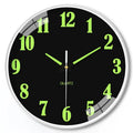 Modern 8-inch luminous wall clock with white face and black numbers on a wall.