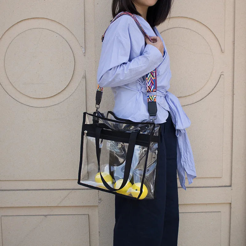 Women's transparent PVC crossbody messenger bag with a black side net pocket, shown in a horizontal square shape.