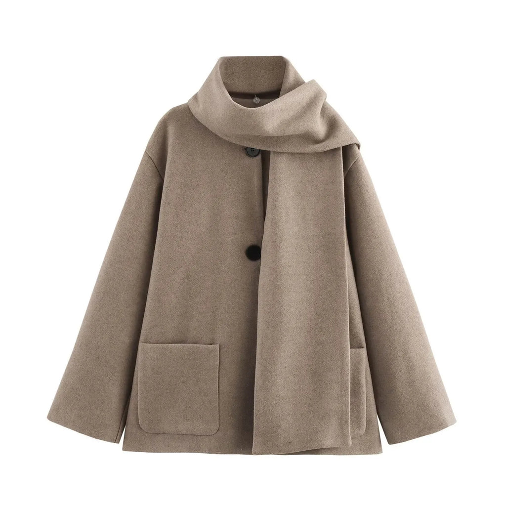 Women's long black coat with artificial fur collar, showing extended length and pocket detail.