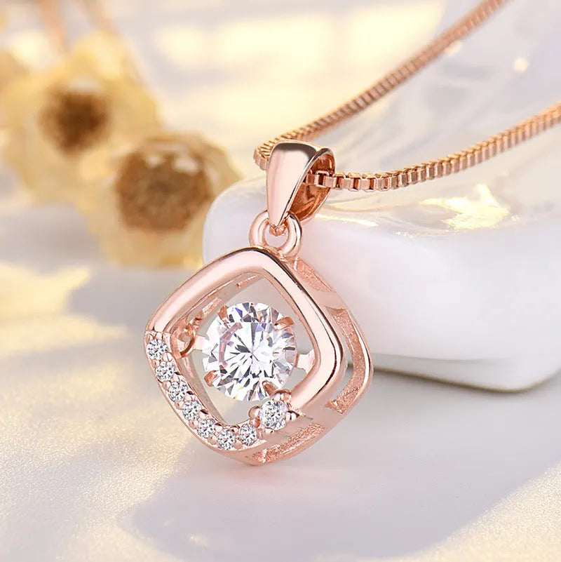 Sterling silver heart necklace with crown detail on a 45 cm chain, shown in silver and rose gold finishes.