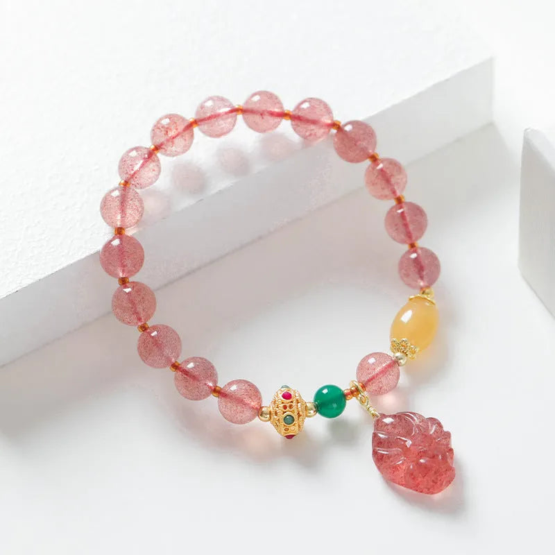 Women's Nine Tail Fox style strawberry quartz crystal beaded bracelet on wrist