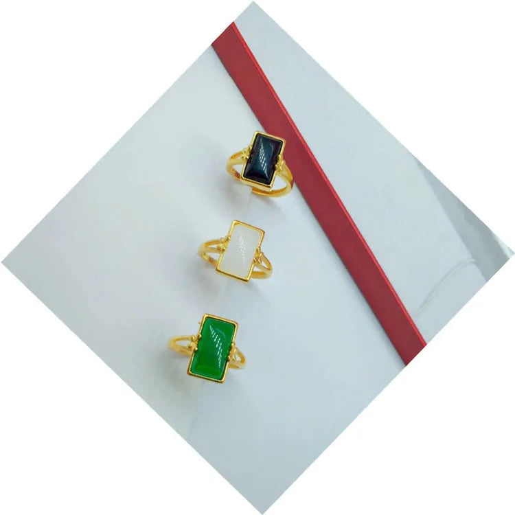 Adjustable brass gold-plated ring with a green gemstone inlay in a national style.