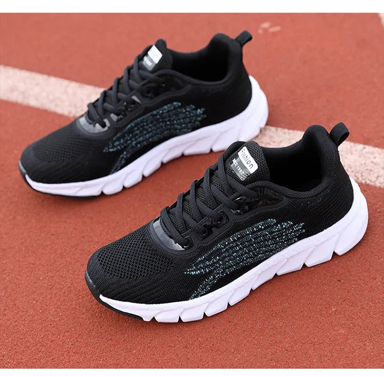 Women's black and white casual running sneakers with cross strap design and MD sole