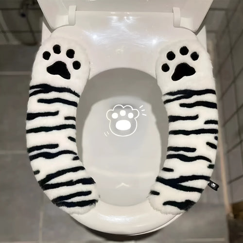 Plush toilet seat cushion with adhesive Velcro fastener in black and white stripes for bathroom use
