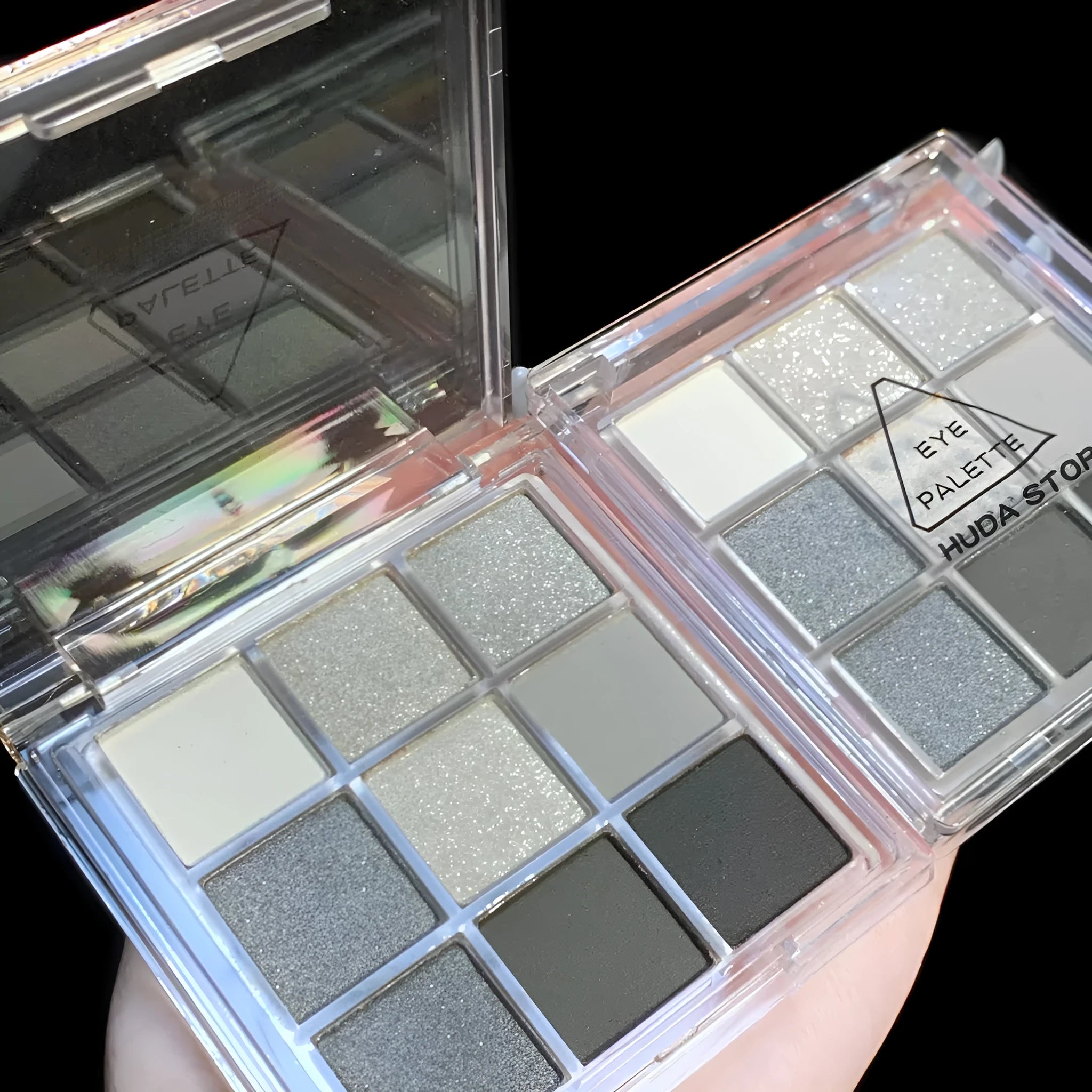 Smoked nine-colour eyeshadow palette with white, silver, black, and iron grey shades.