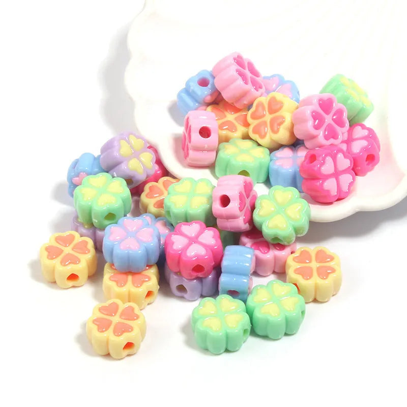 Assortment of 15mm frosted acrylic four-leaf clover beads in rose red, pink, yellow, green, blue, and purple.