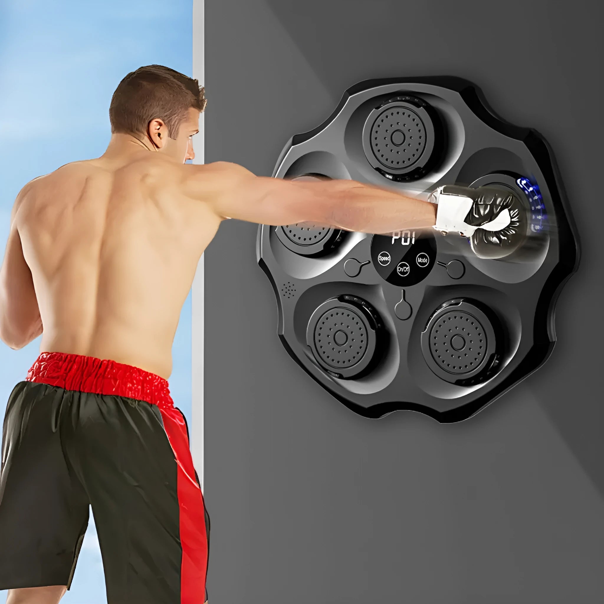 Black Bluetooth music boxing wall target hanging on a wall with gloves.