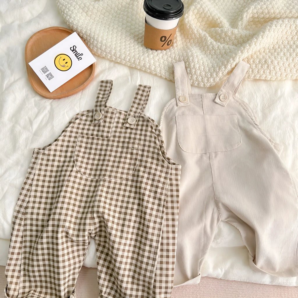 Infant cotton corduroy overalls in creamy white with large front pockets and double-breasted closure