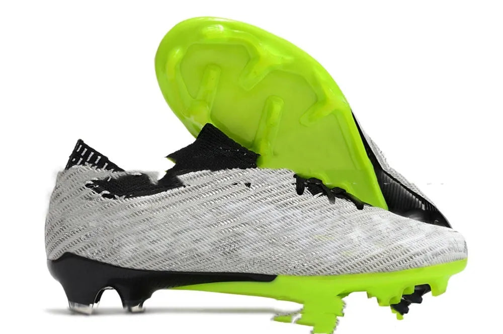 Men's low-top football shoes with knitted upper, rubber outsole with FG studs, shown in a front lace-up style.