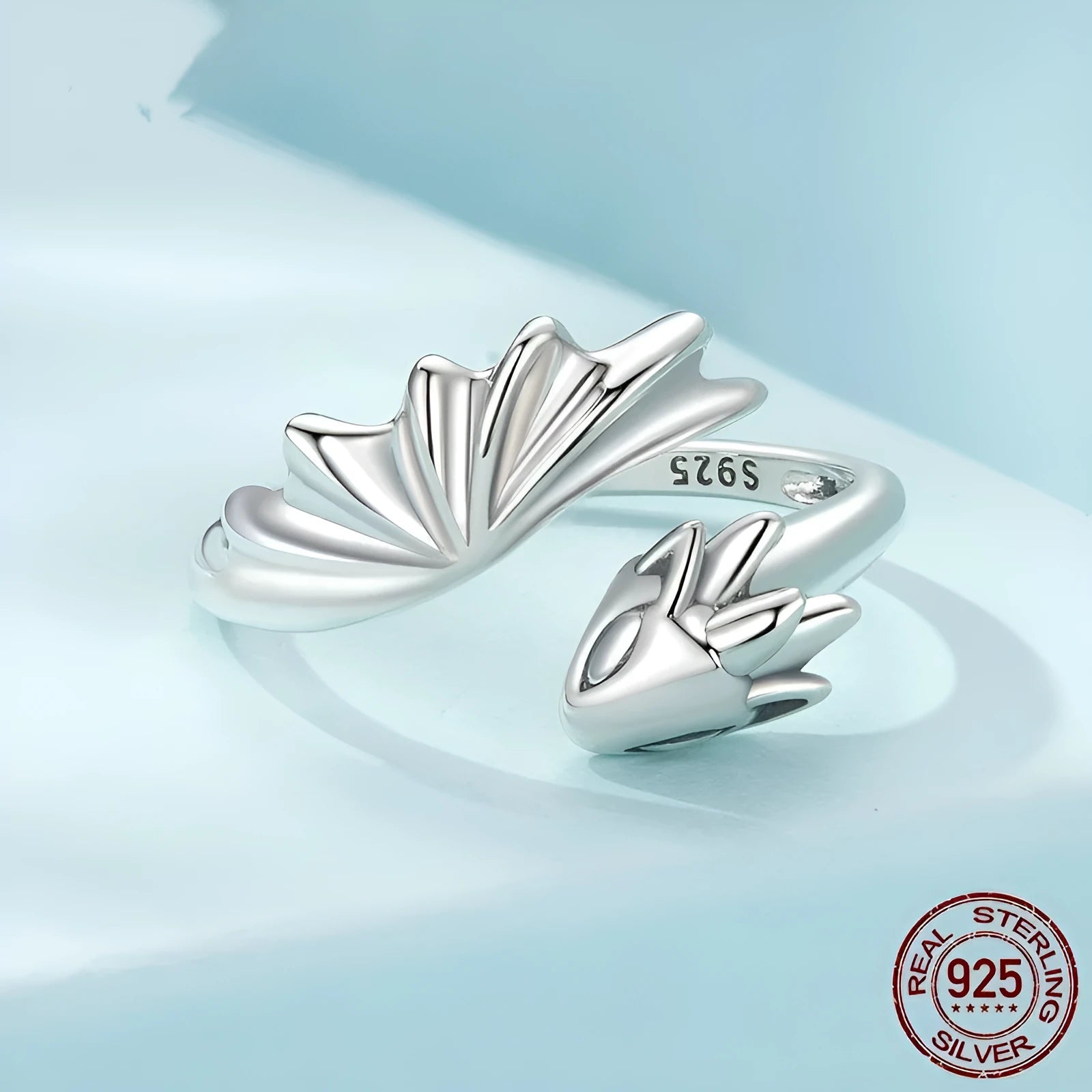 Unisex silver adjustable open ring with flying dragon wing motif on neutral background