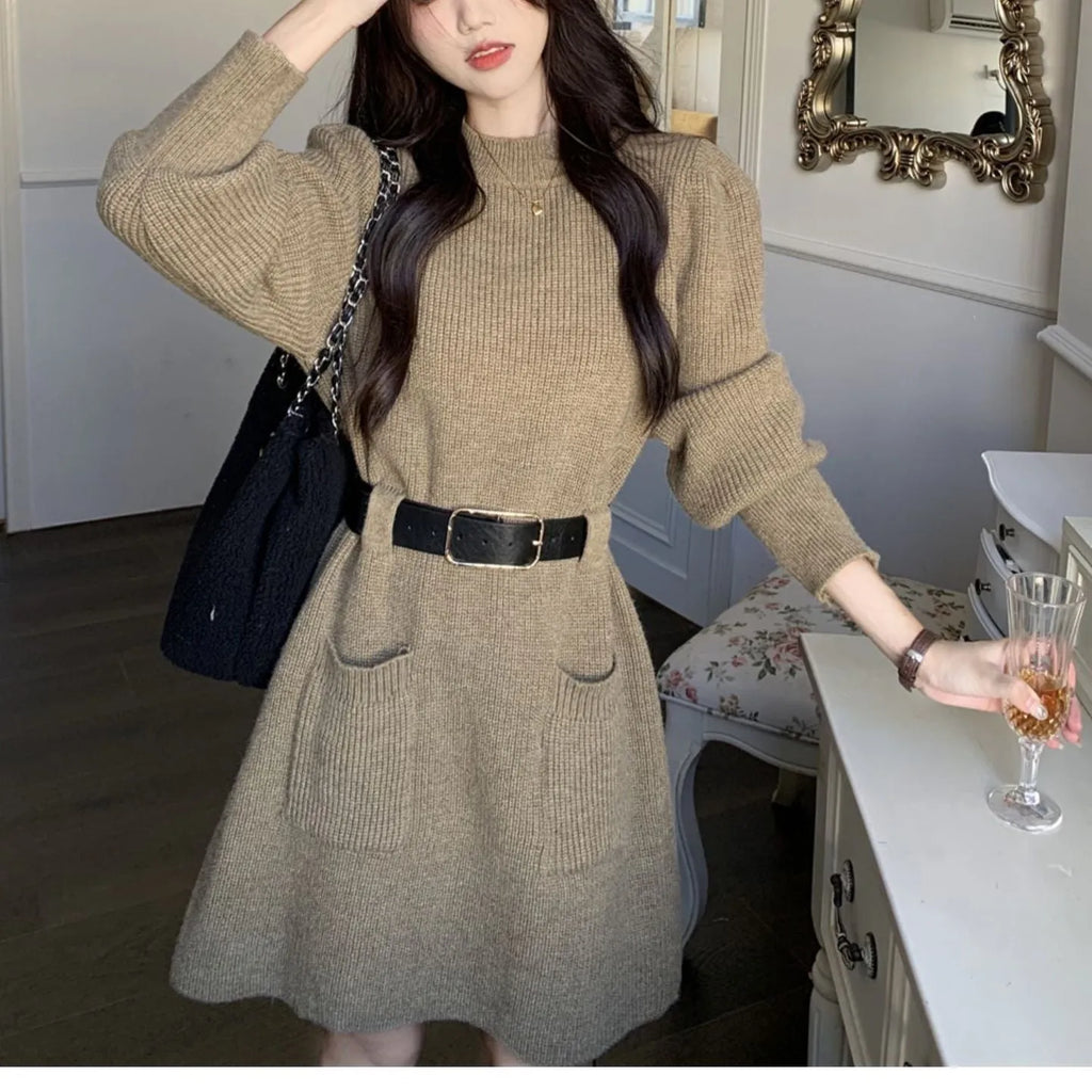 Women's loose knitted dress with long sleeves and high waist, shown in beige with black belt