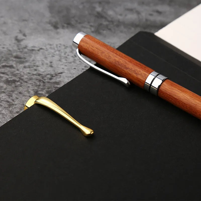 Wooden metal ballpoint pen with rosewood barrel on white background