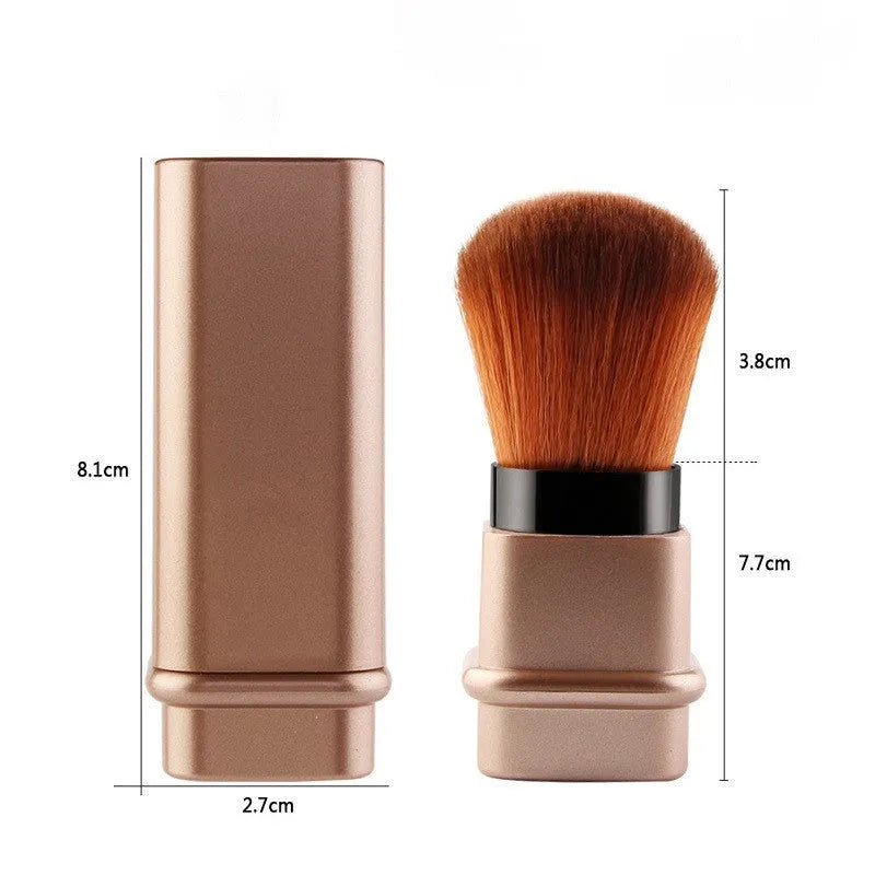 Portable single makeup brush with man-made fibre bristles and square gold plastic handle on white background