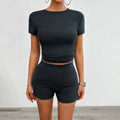 Women's solid colour viscose fibre two-piece sports set with slim-fit t-shirt and elastic shorts.