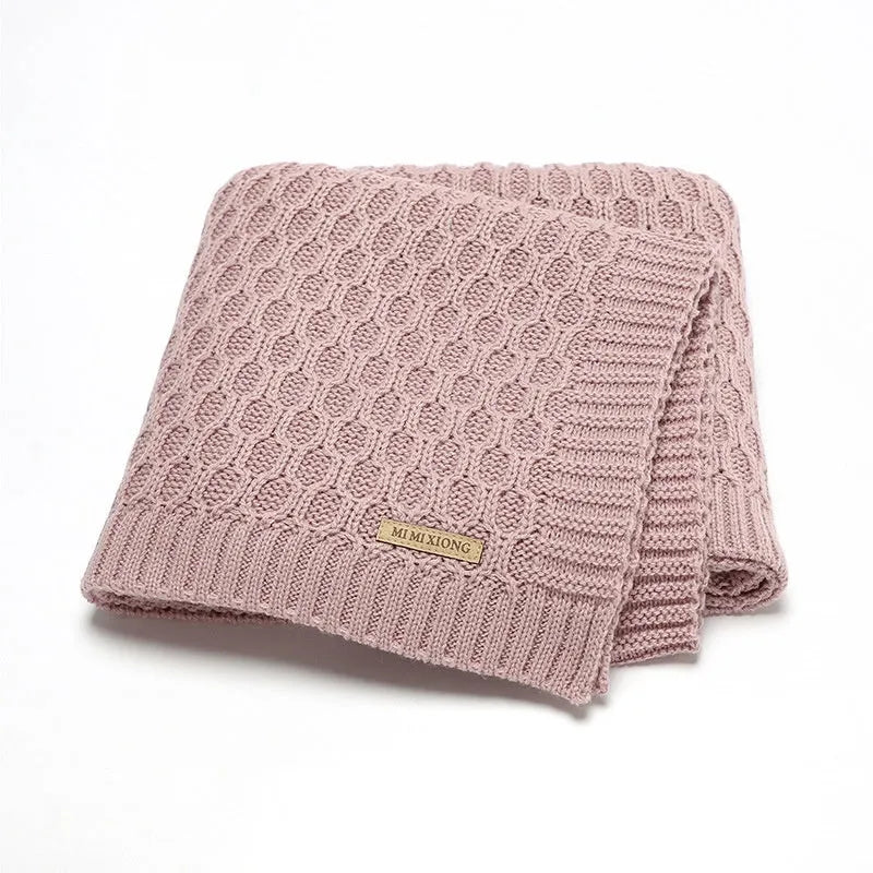Solid colour acrylic infant hug blanket with three-dimensional lines, shown in a light green colour.