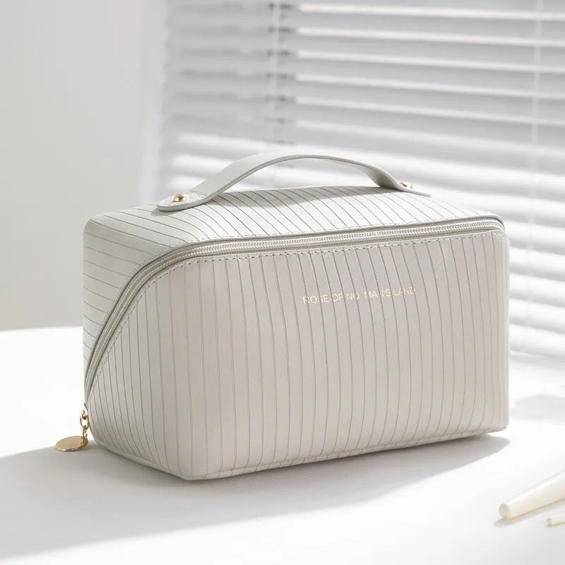 Vertical pattern pillow makeup bag in a cubic shape with large capacity for travel storage.