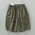 Men's loose straight leg linen shorts in green with drawstring waist and mid thigh length