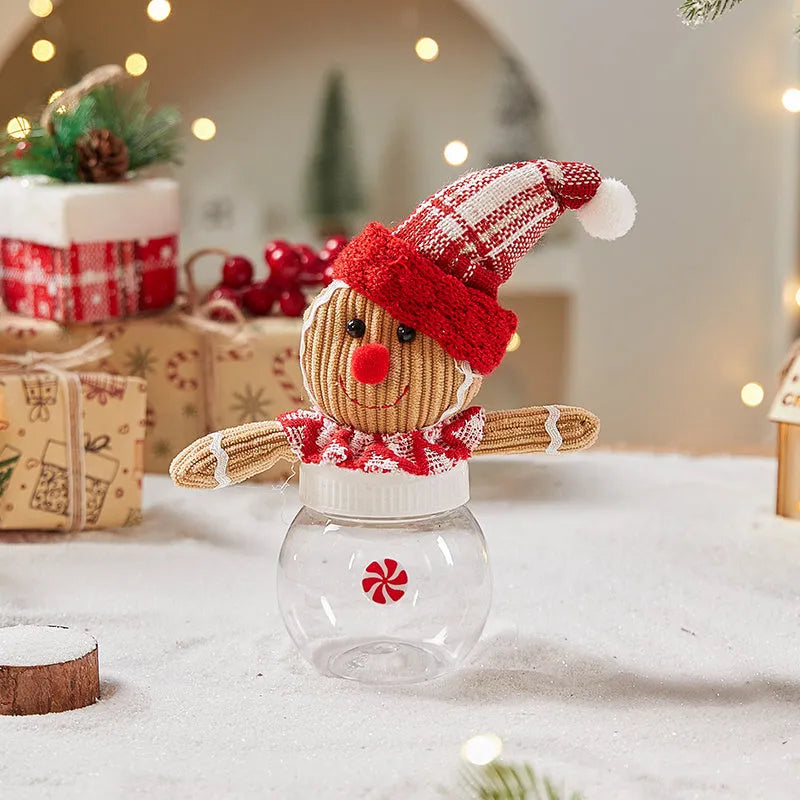 Cloth gingerbread man Christmas ornament with red hat hanging on festive branch