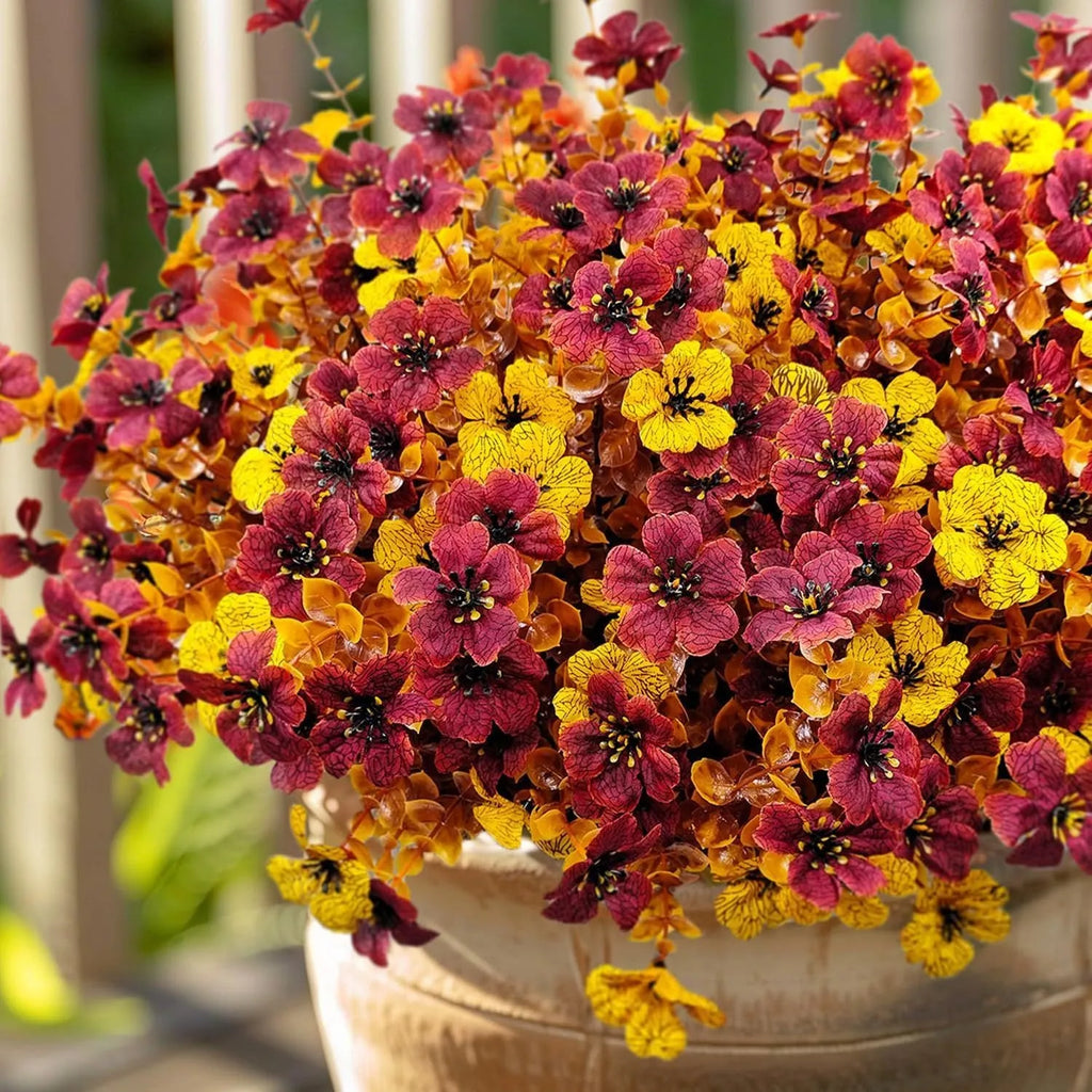 Artificial flower bouquet with autumn orange, red, and yellow silk flowers on plastic stems for decoration