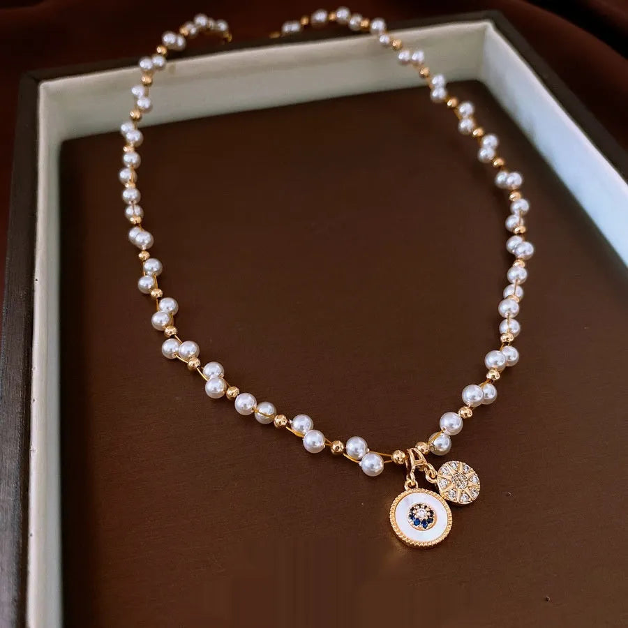 Gold electroplated necklace with round zircon and imitation pearl pendant on clavicle chain