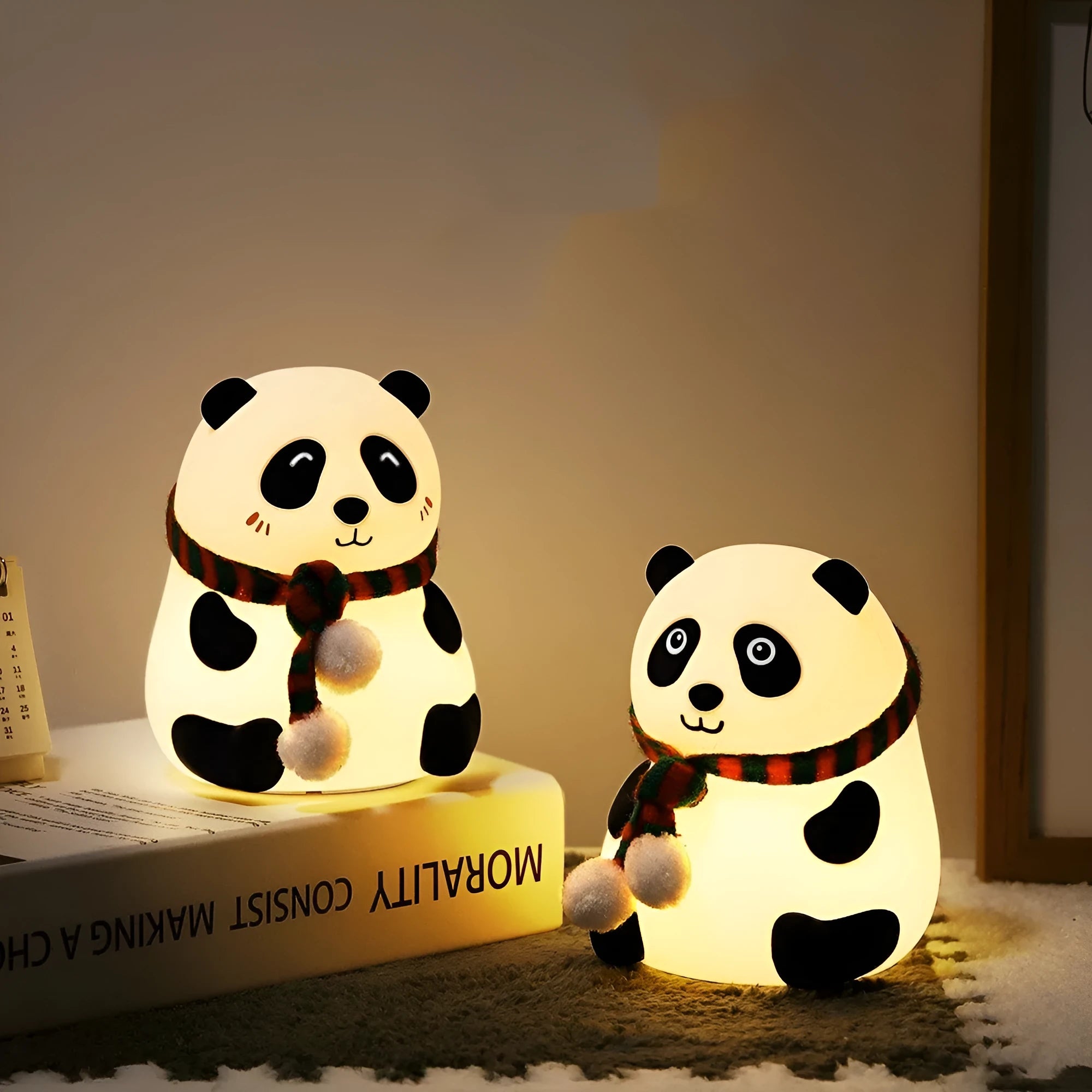Panda-shaped silicone night light with USB cable on a wooden surface