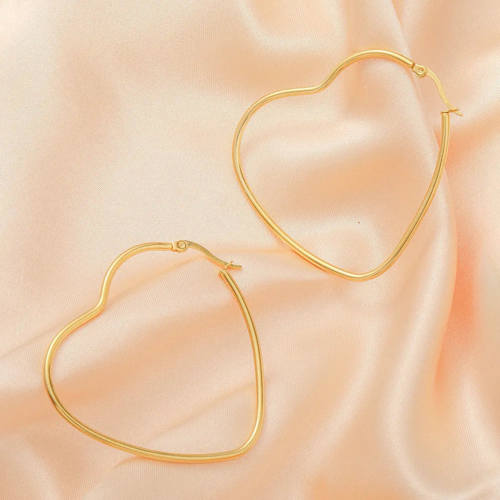 Golden metallic heart-shaped ear clip for women made from twisted electroplated stainless steel