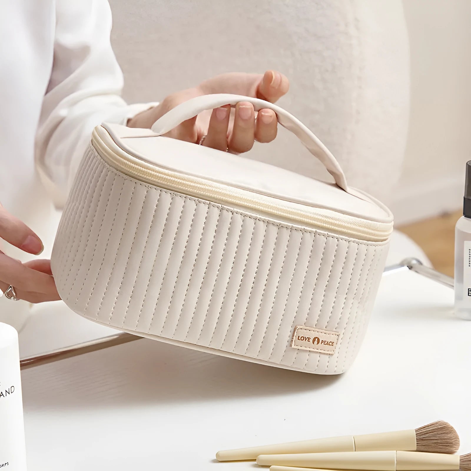 Open-top PU leather makeup bag in a solid colour, showing cosmetics and brushes inside.