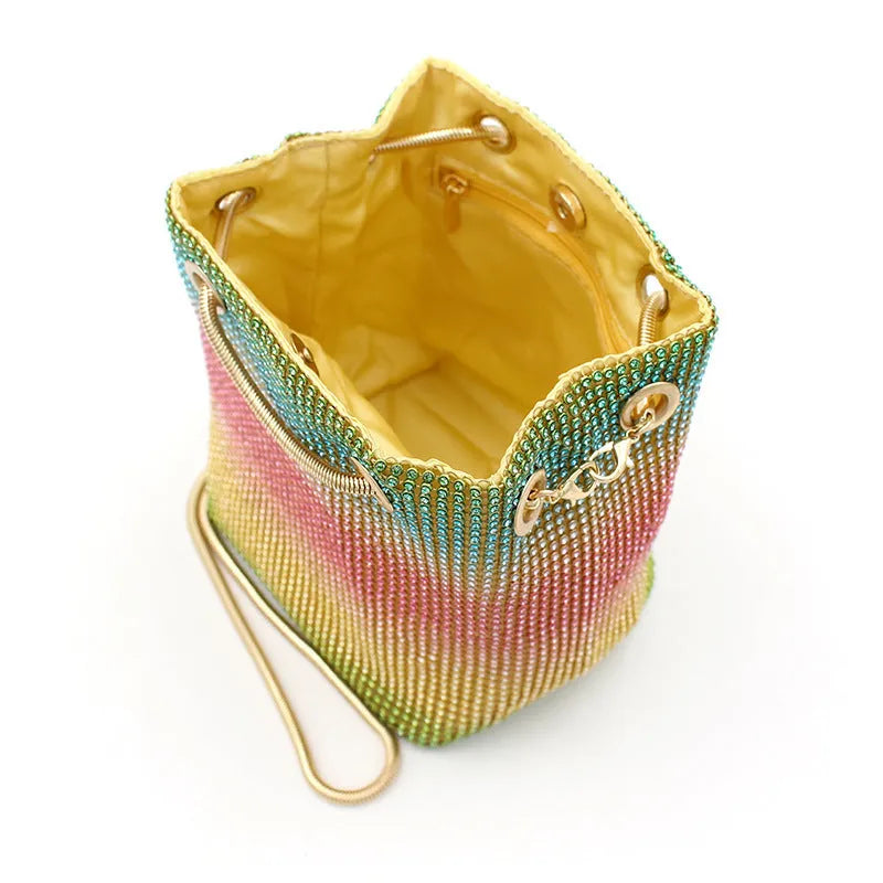Soft rainbow rhinestone bucket bag with adjustable strap, shown in multicoloured sparkle.