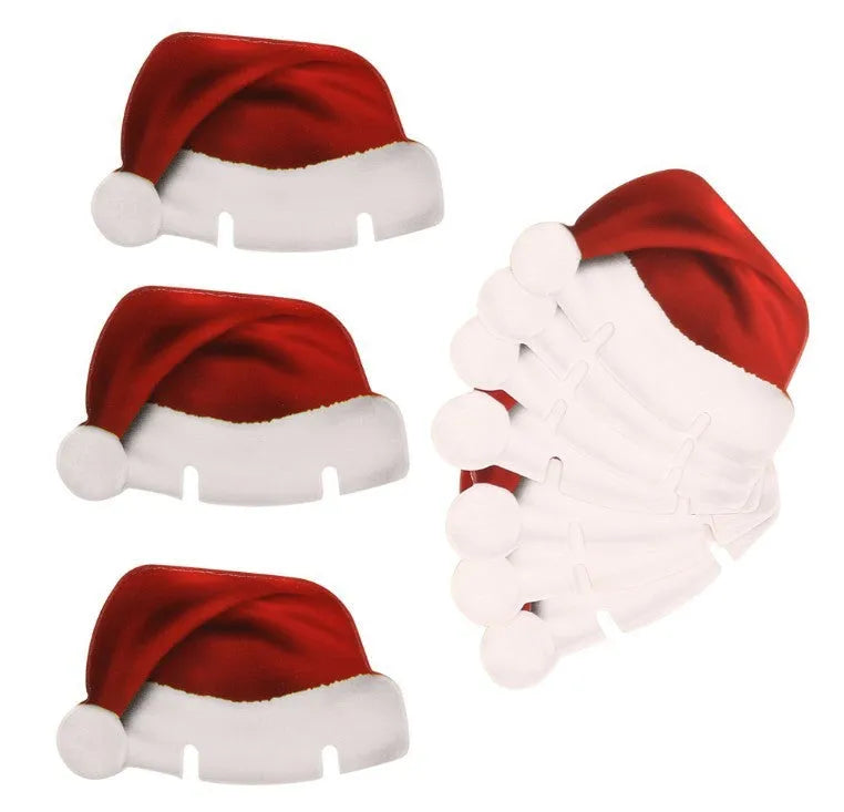 10 red paper Santa hat wine glass toppers on a Christmas table