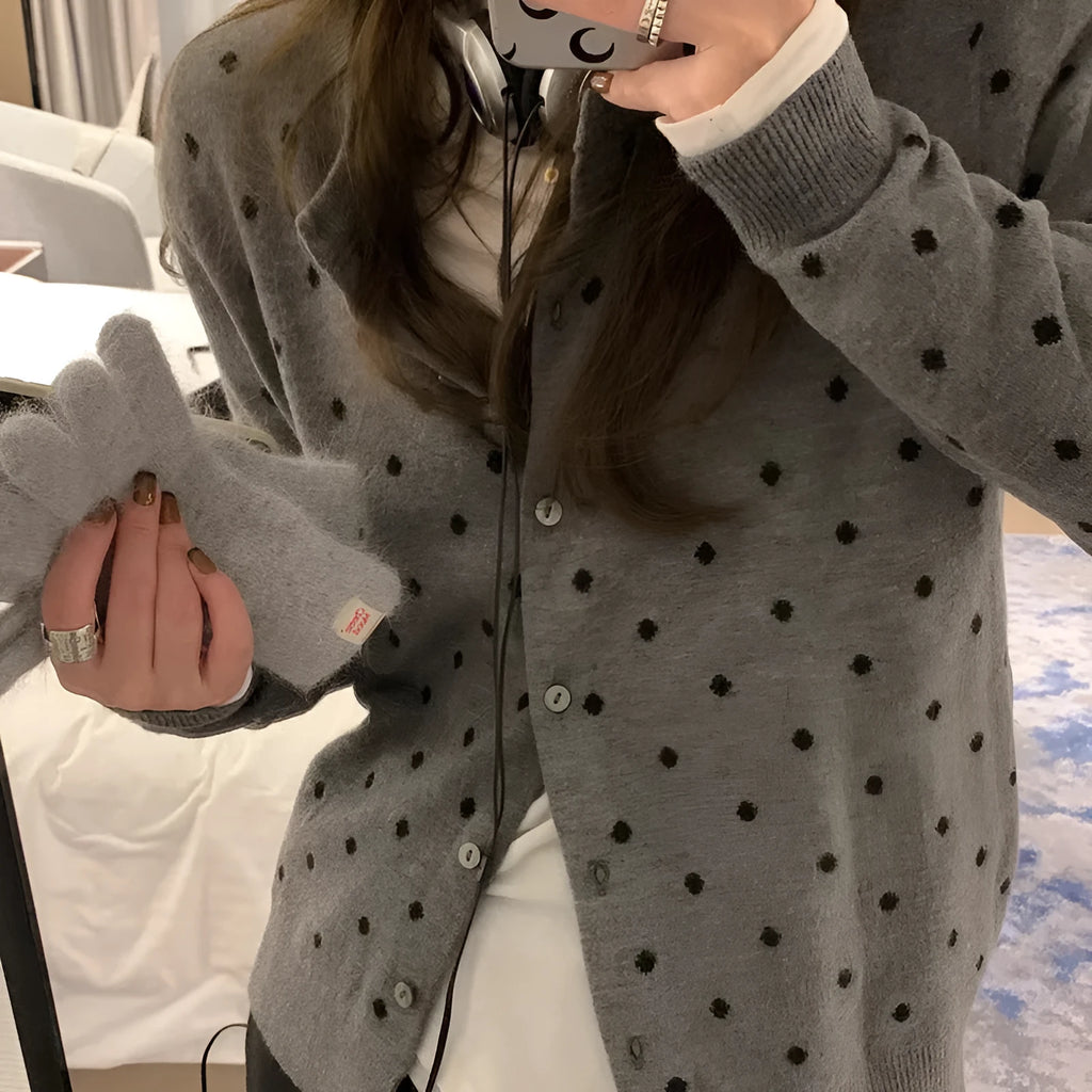 Women's grey dot pattern knitted cardigan with crochet flower detail, long sleeves, loose fit.