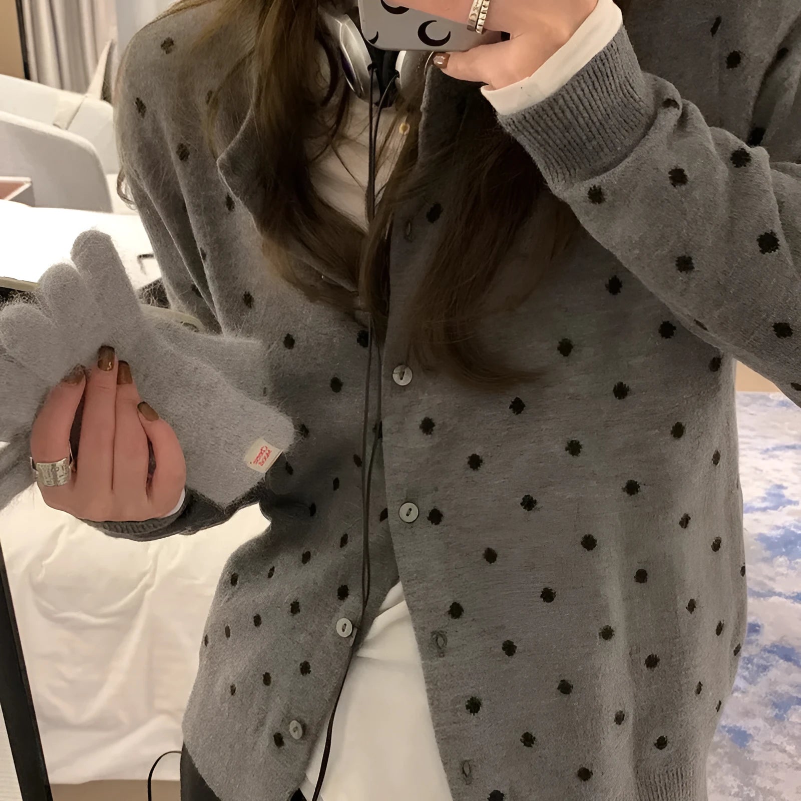 Women's grey dot pattern knitted cardigan with crochet flower detail, long sleeves, loose fit.