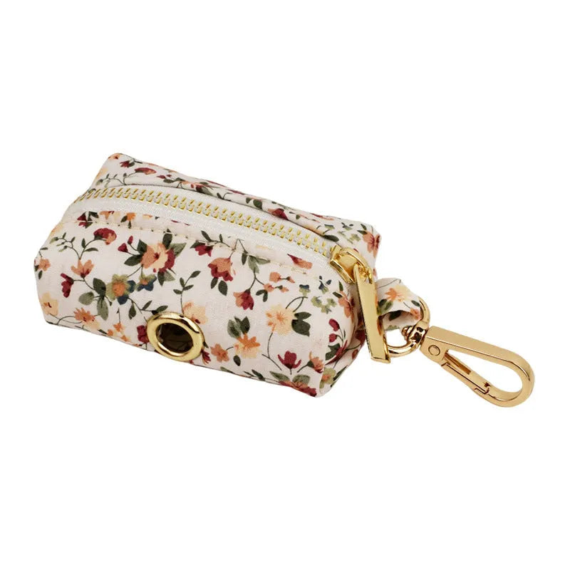 Small white flower pattern dog collar set with matching leash, vest, and bow on a mannequin.