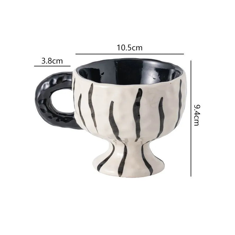 Hand-pinched irregular shaped ceramic mug in a solid colour on a plain background.