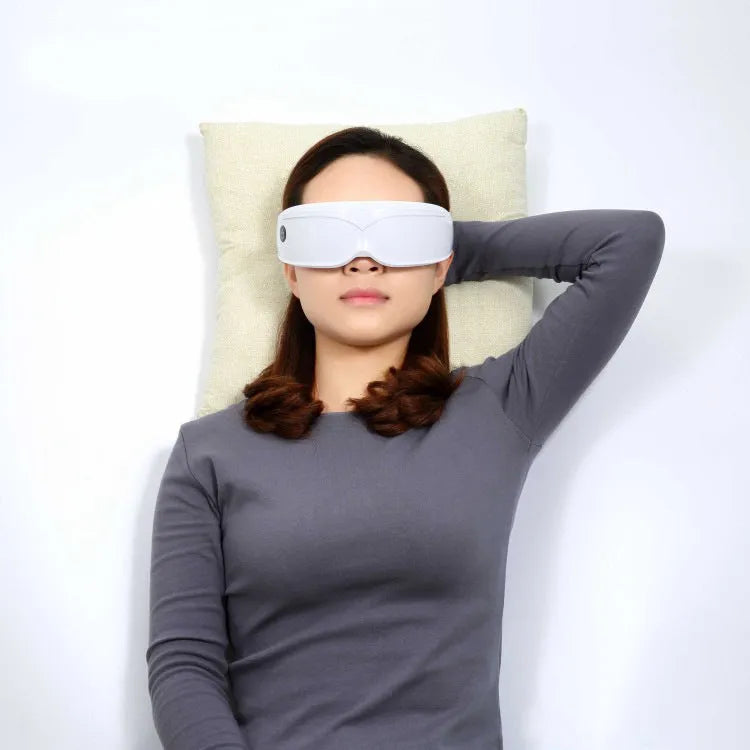 Eye massager with adjustable headband, silicone contacts, and 9 vibration modes in black and white colour