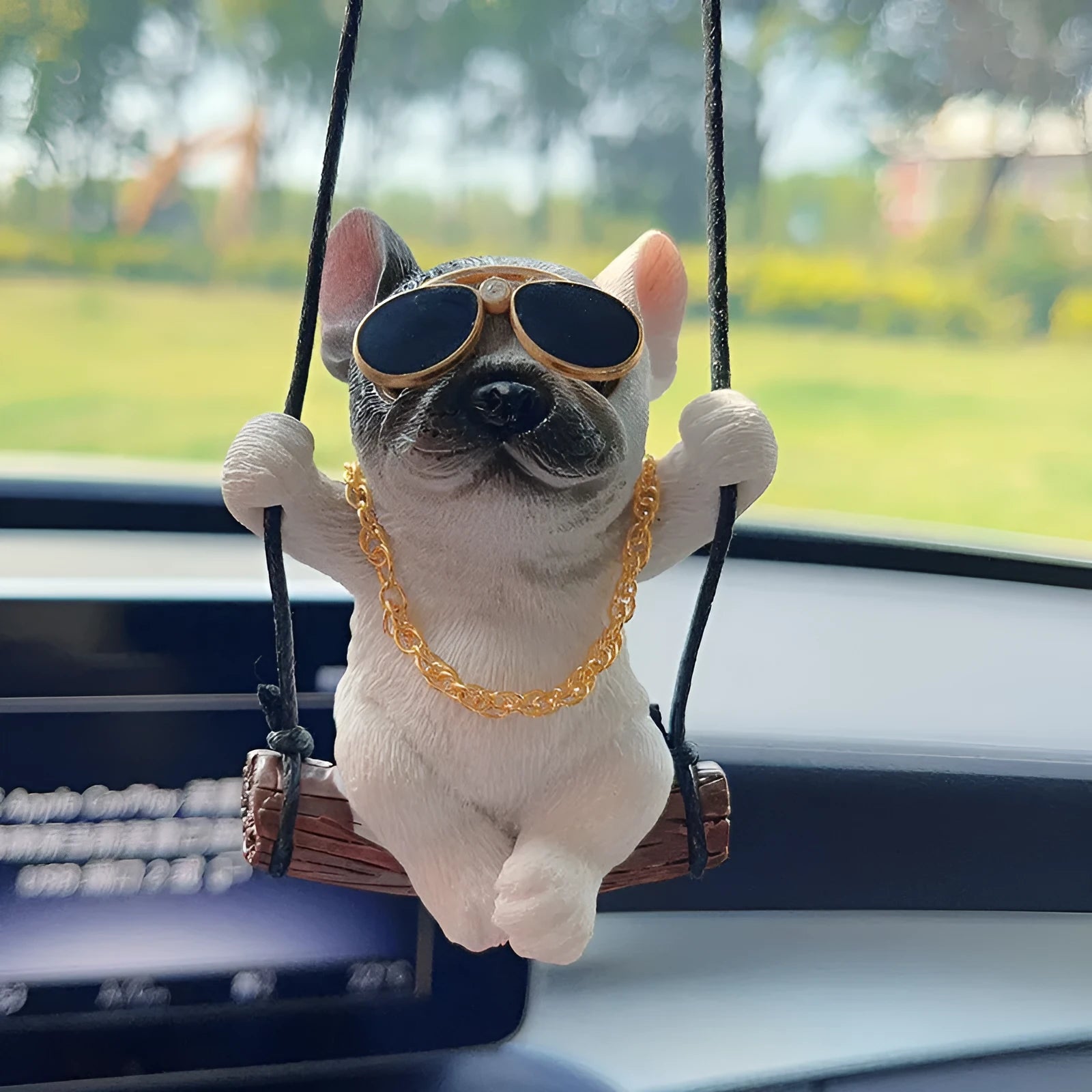 Small resin bulldog cartoon pendant for hanging on a car rearview mirror.
