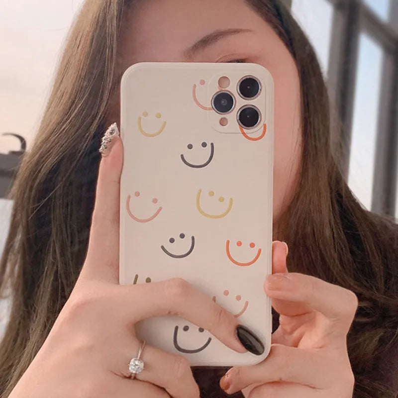 Simple silicone iPhone case with smiley face design in multiple colour options