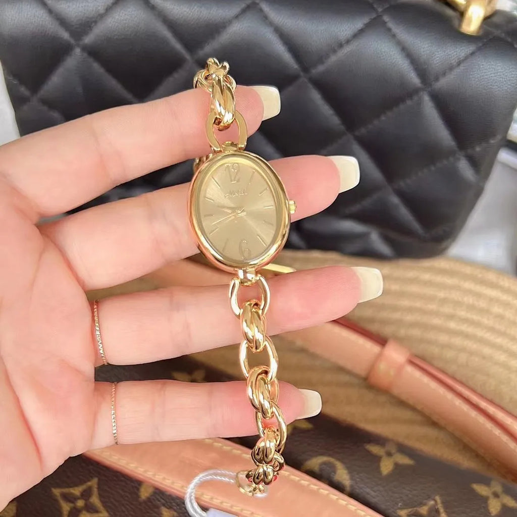Ladies steel strap watch with oval hollow chain, silver case, white face, casual style