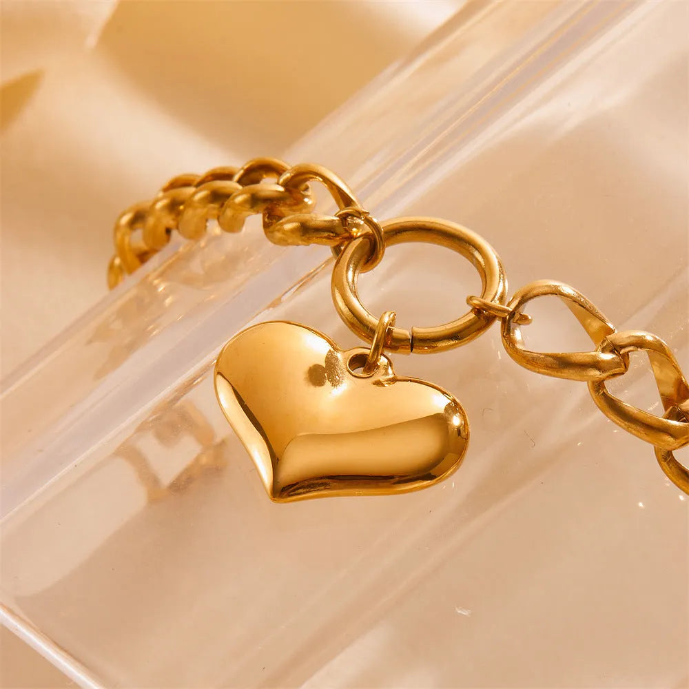 Titanium steel round chain bracelet with heart charm and petal detailing in gold N510
