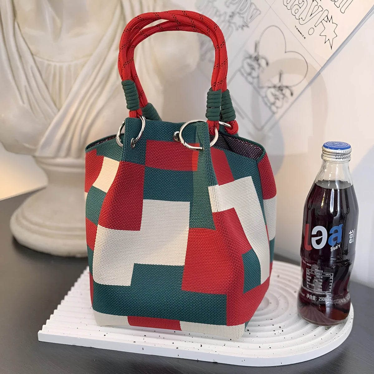 Knitted loop handle bag in checkered red and green, vertical square shape, polyester lining, mobile phone pocket.
